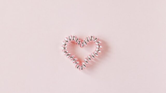 decorative heart of elastic coil on pink background