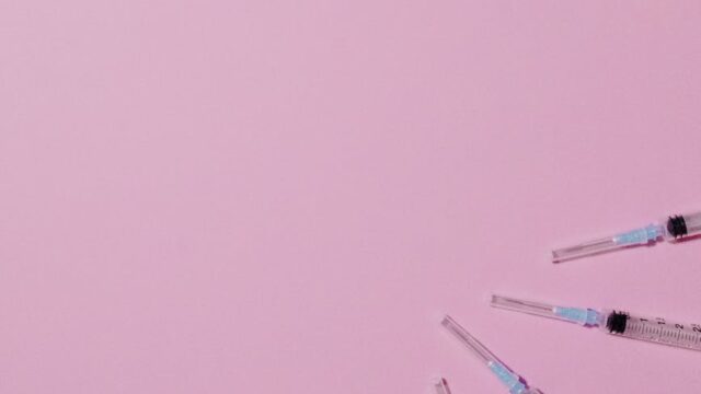 plastic syringes on purple background