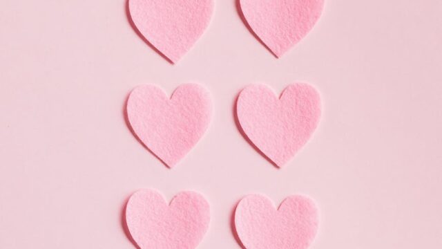 heart shaped cutouts on pink background